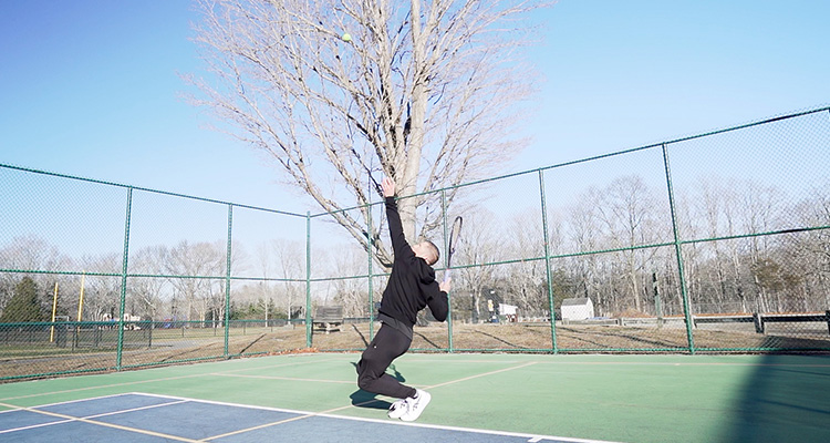 Jon Crim Hitting a Serve with Luxilon 4G