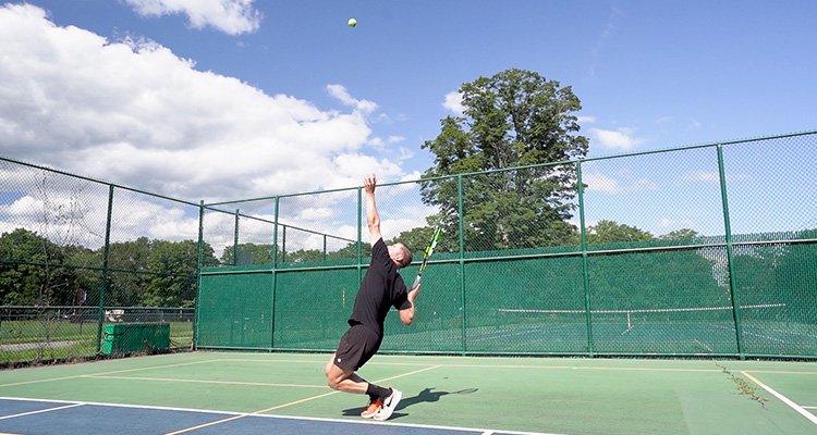 Jon Crim Hitting a Serve with the Babolat Pure Aero 2023